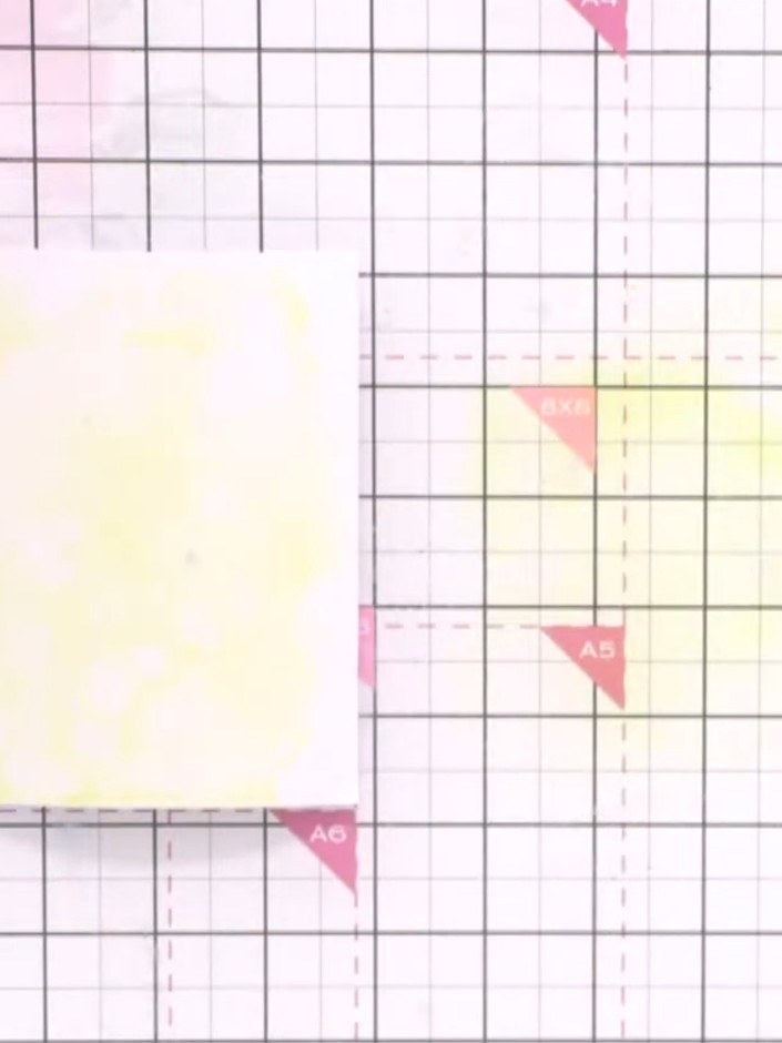 Step 3: Press your wet card face down into the yellow ink puddle, allowing the colour to transfer and blend across the