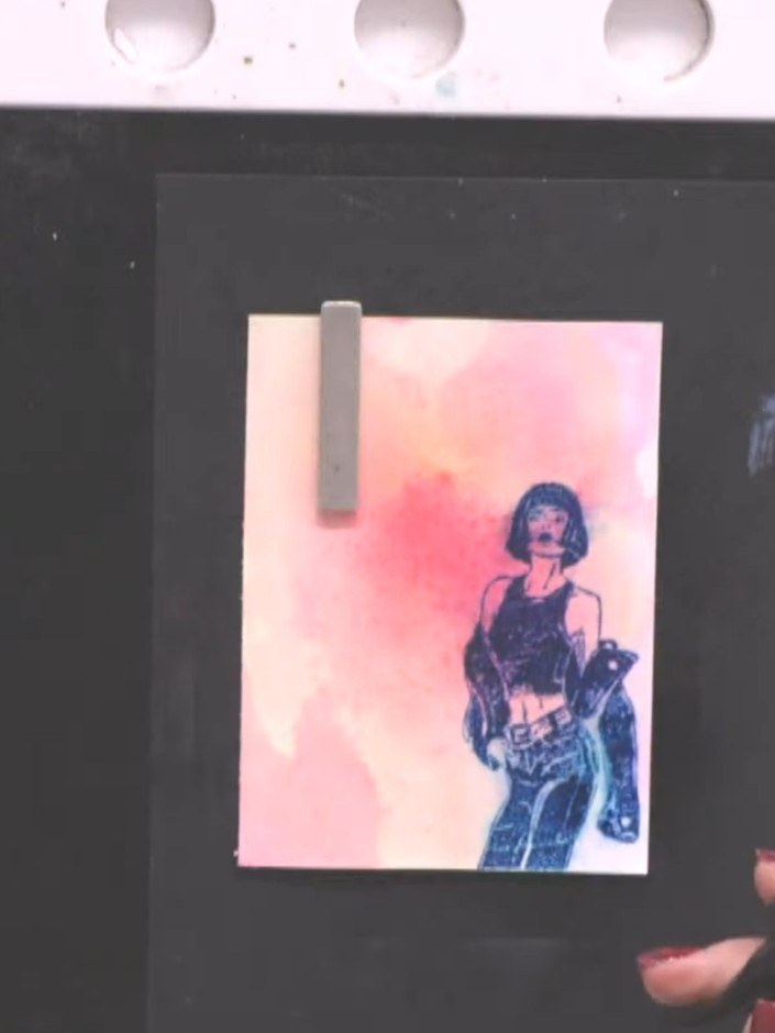 Step 8: Lightly spray the stamped image with water to create a fuzzy, bled effect around the edges, allowing the colou