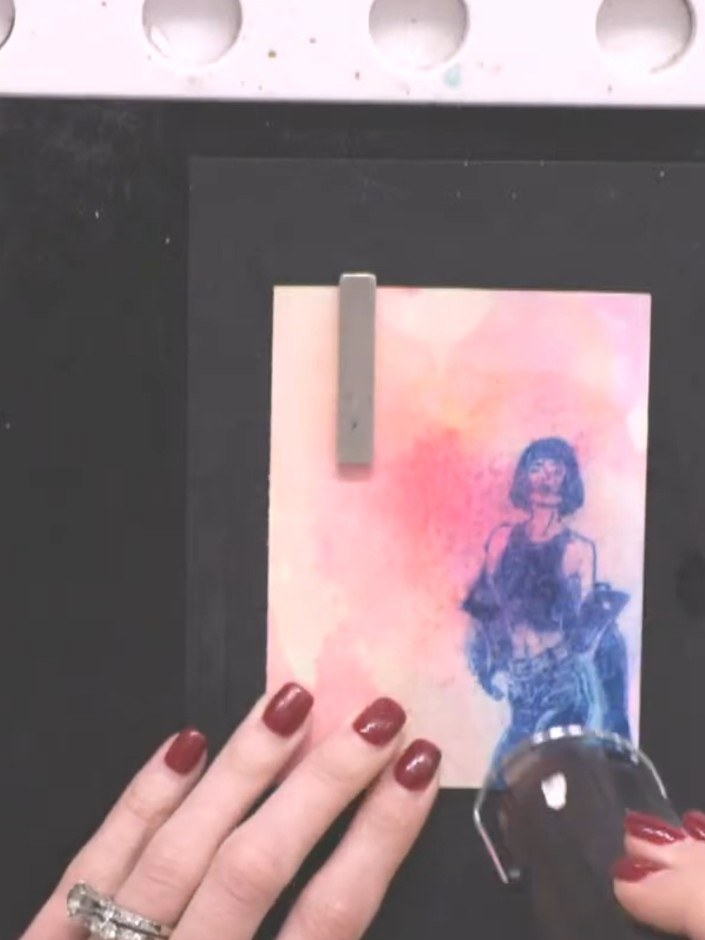 Step 9: Once the watercolour wash is completely dry, re-stamp the same lady image directly over the top using black in