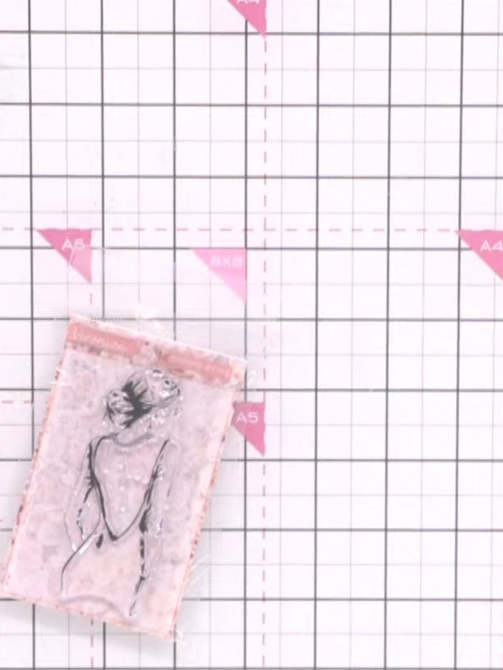 Step 2: Stamp the lady image in black ink directly onto the patterned paper. Position the stamp carefully to ensure th