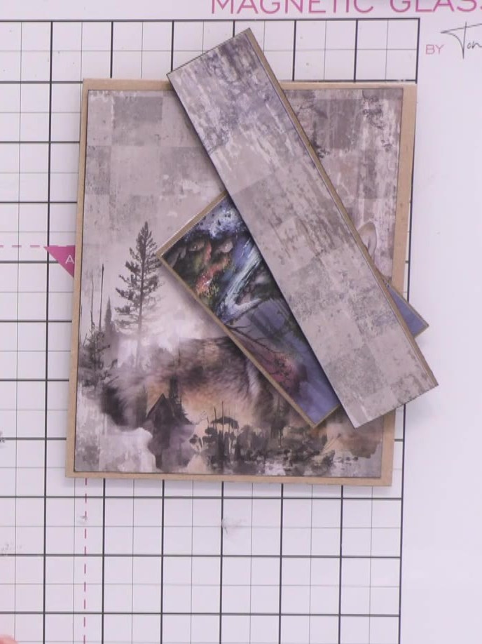 Step 1: Select a patterned paper from the Great Outdoors kit featuring the wolf and forest imagery. This will be used 