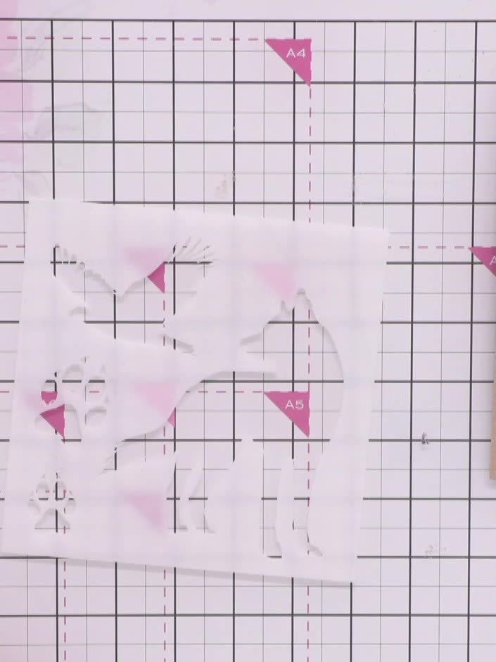 Step 2: Place the wolf mask stencil on your chosen patterned paper and secure it in position with low-tack tape to pre