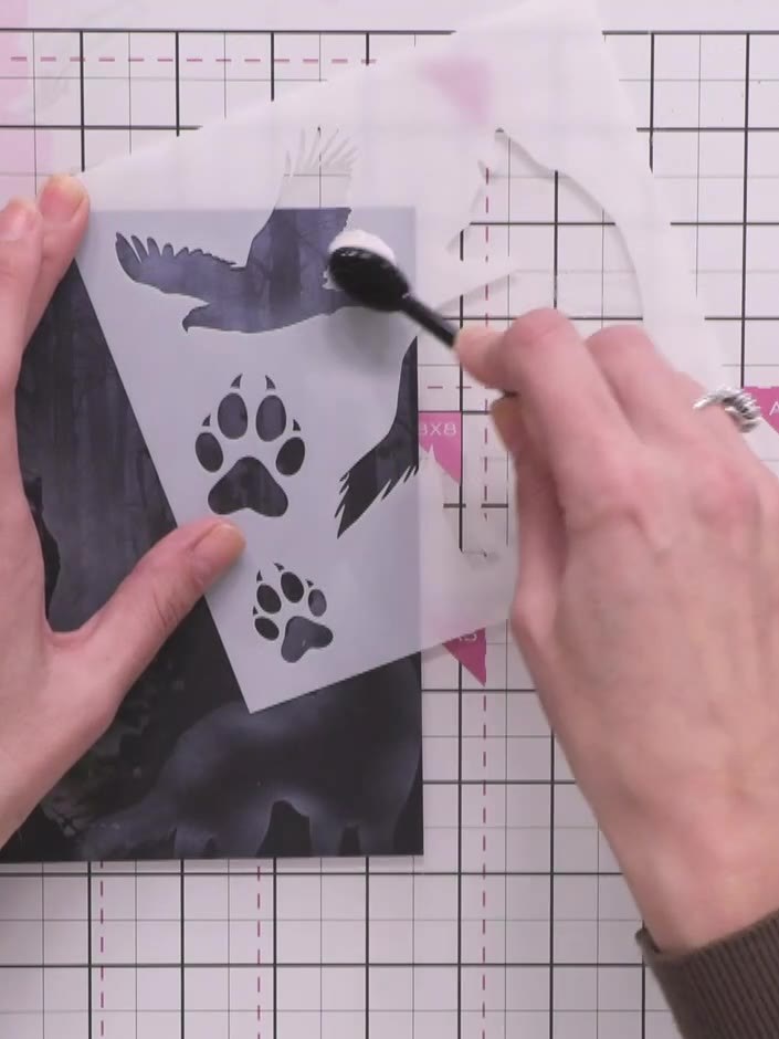 Step 6: Position the hiker stamp image so that the wolf appears to be watching over him in the forest scene. Hold the 