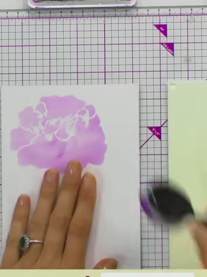Step 3: Remove the stencil carefully from the card stock. Allow the pink and purple ink to dry completely before proce