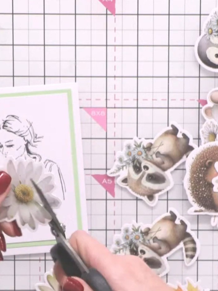 Step 6: Arrange the floral embellishments around the lady image on your card front. Position the daisies, animals and 