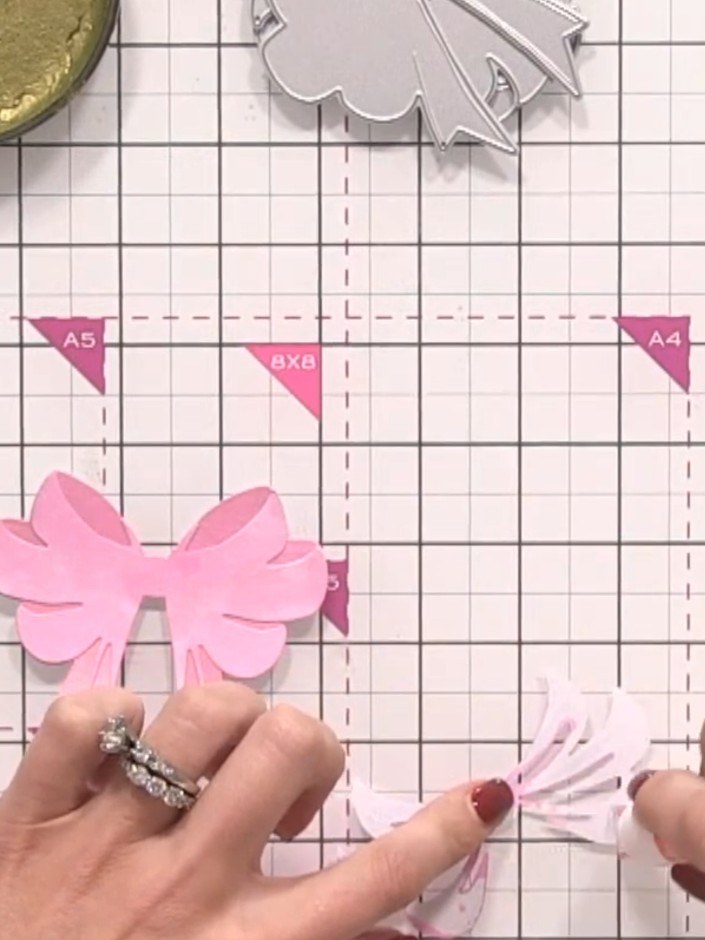 Step 8: Layer the three pink bow pieces together with the largest piece at the bottom and the smallest piece on top. A