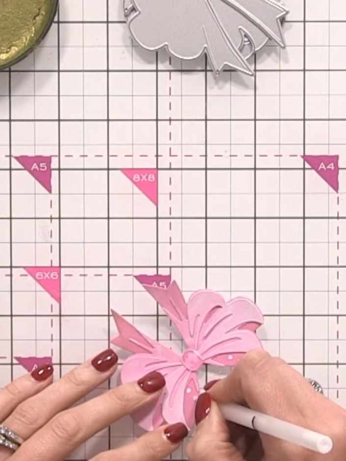 Step 9: Use a fine-tipped white gel pen to add decorative spots across the pink bow. Include half-spots along the edge