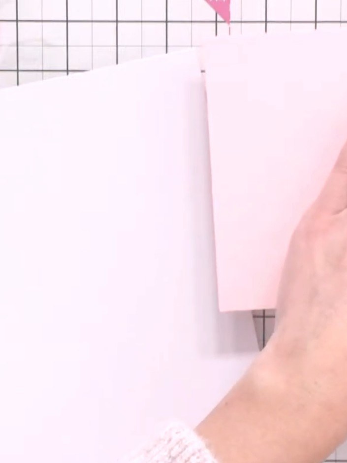 Step 1: Cut down a pink card blank to create a panel. Cut white card panels to layer beneath the pink panel for a mat 