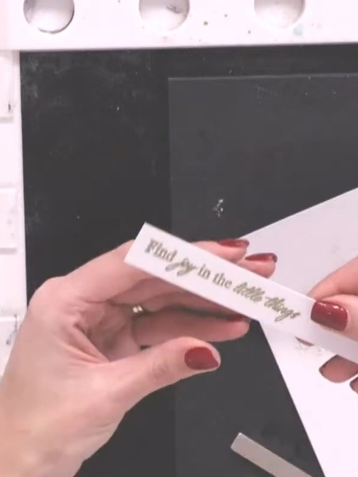Step 7: Heat set the embossing powder using a heat gun to create a raised, shiny finish on the stamped sentiment. Hold