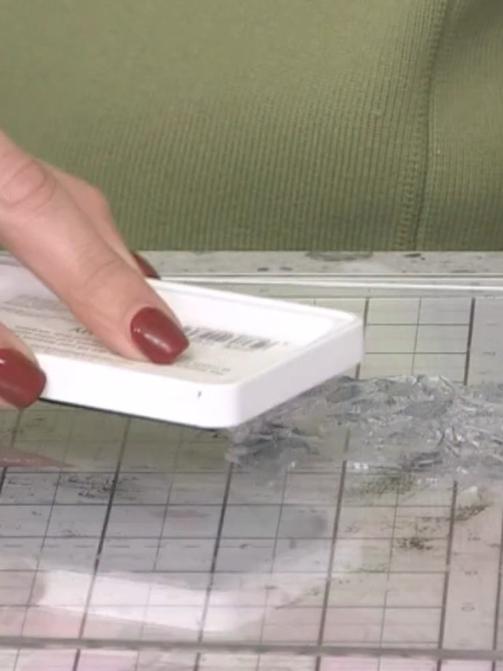 Step 3: Spray the inked stamp three times with water to create a watercolour effect. This will help the ink blend and 