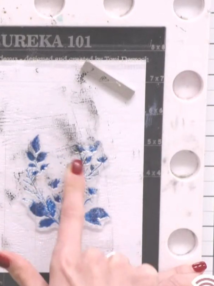 Step 4: Press the stamp firmly onto your card with blue floral design. Hold it steady for a moment to allow the card t