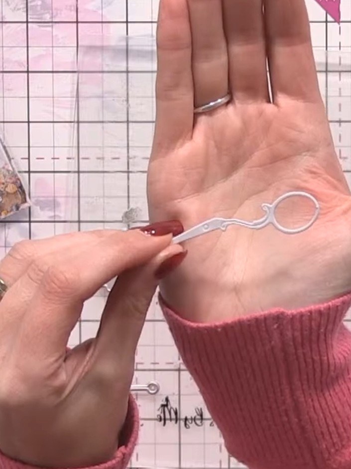 Step 2: Thread gold thread through the die-cut needle piece to add a single colour accent to your white-on-white desig