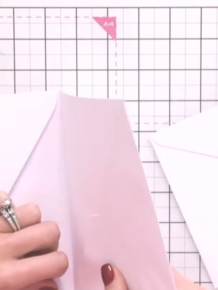 Step 2: Tuck the taped envelope inside the second envelope, corner to corner, and press down firmly to create your bas