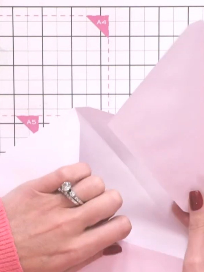 Step 3: Apply tape to the flap of a third envelope, positioning it slightly away from the score line to ensure the alb