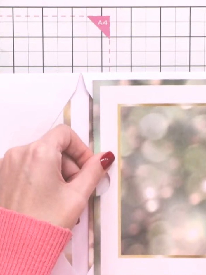 Step 7: Adhere the decorated mat and layer to the front of your pocket envelope, positioning it centrally over the gol
