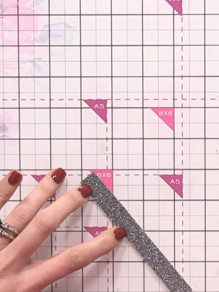Step 13: Add a decorative black sparkle strip along one edge of the card using tape for a finishing touch.
