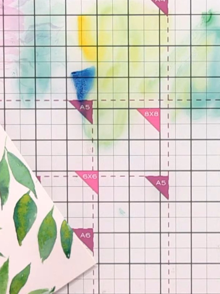 Step 7: Paint abstract flowers by creating light blobs of pink and yellow watercolour on your card. Keep the shapes lo