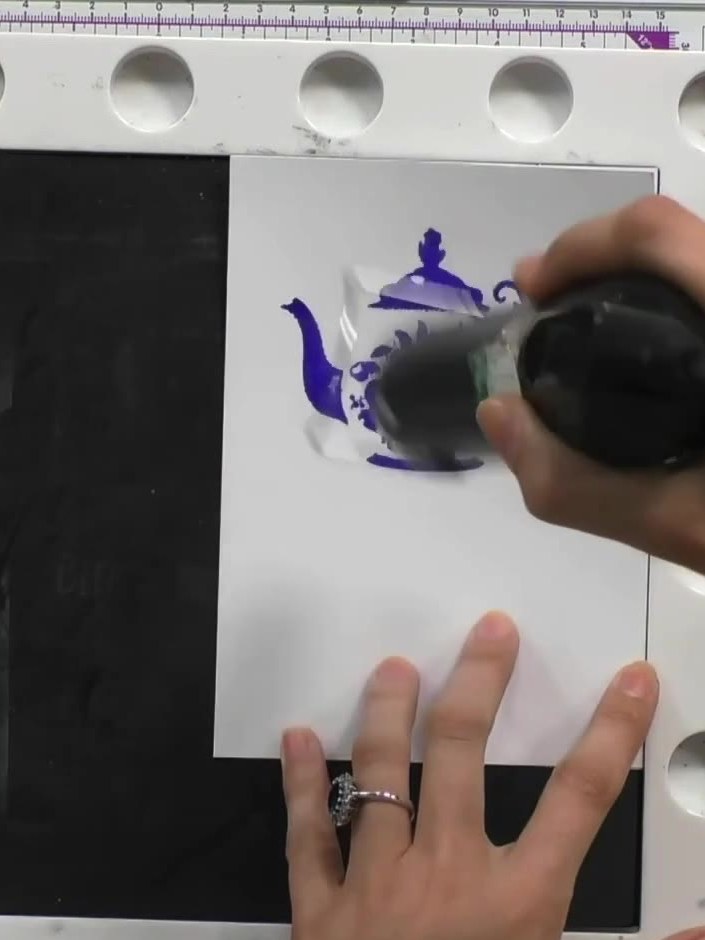 Step 6: Stamp the detail portion of the teapot design on top of the base image to add shadow and definition to the spo