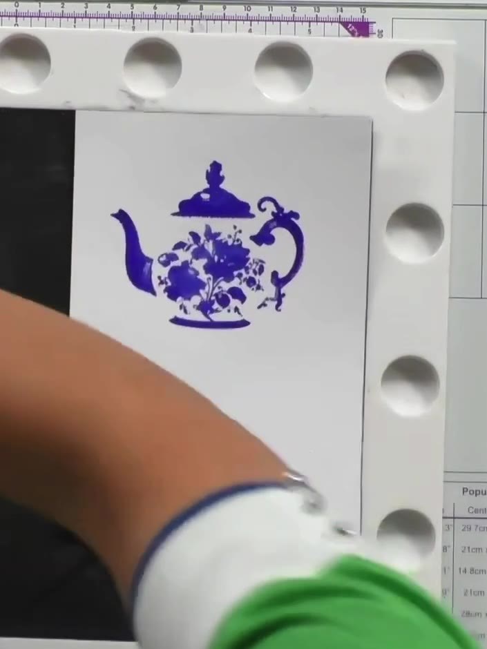 Step 7: Line up the detail stamp over the teapot image using the visual guide on the packet front as reference. Positi