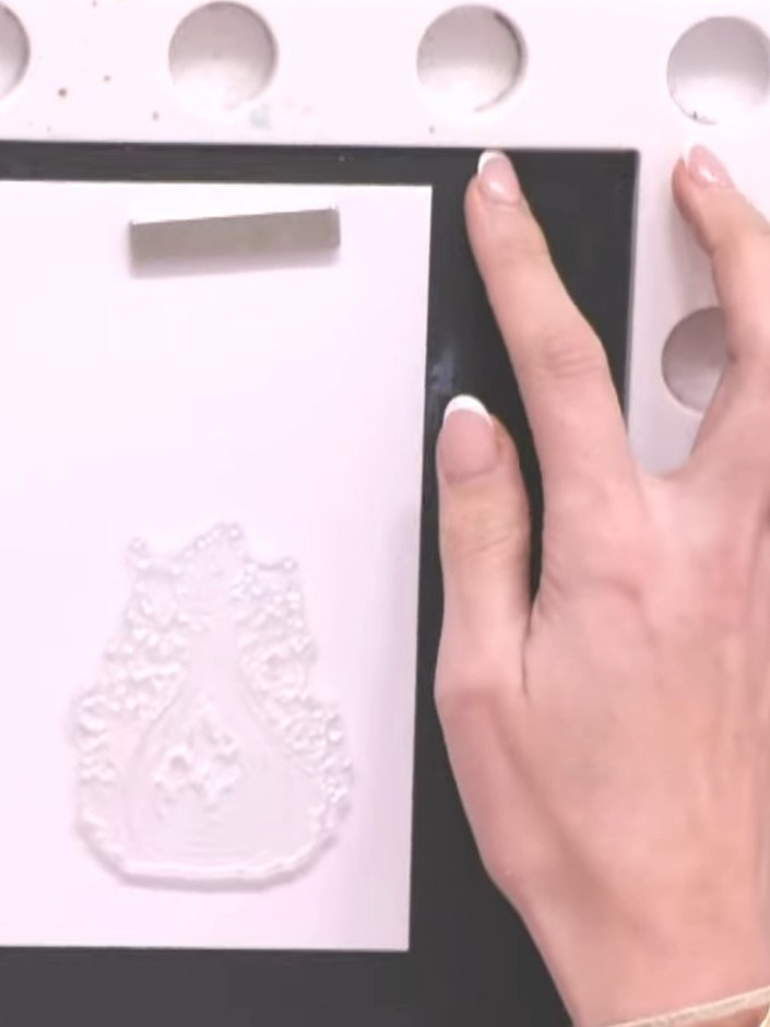 Step 3: Spray the stamped potion bottle image with water three times using a water spray bottle to activate and blend 