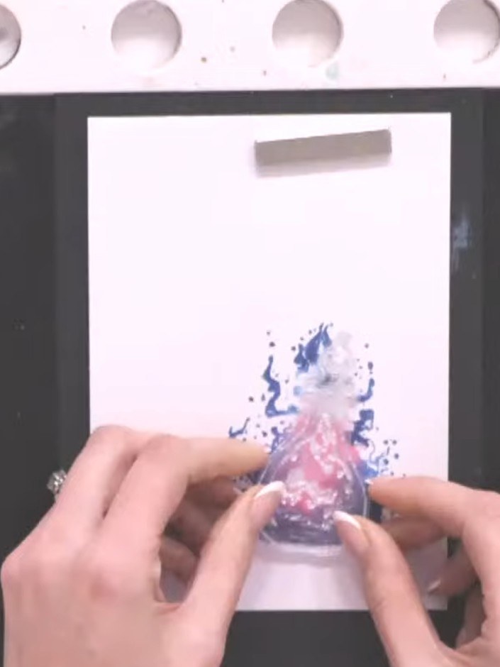 Step 7: Stamp a sentiment such as 'Spell on You' randomly across the white card above the potion bottle to create the 
