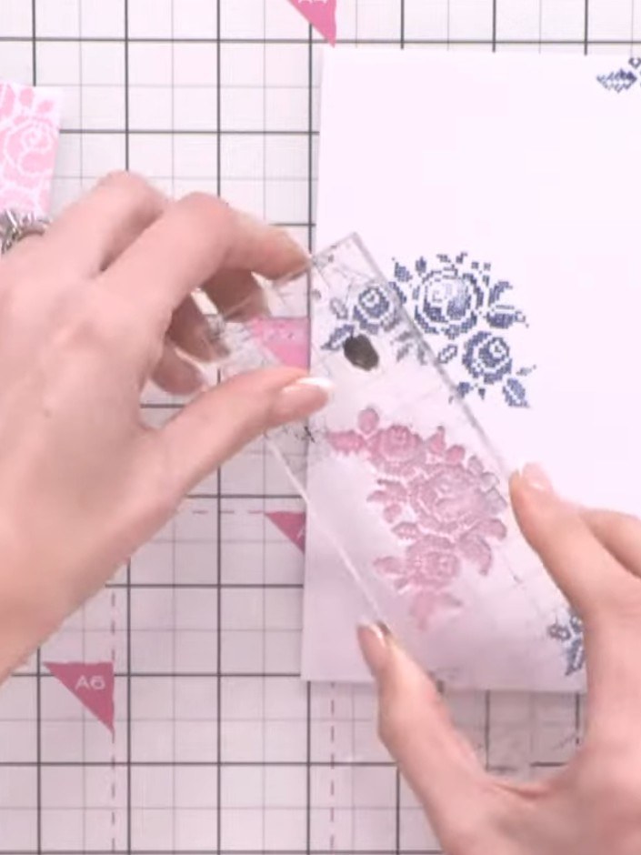 Step 2: Ink the same floral stamp with pink ink and stamp it in different areas of the card to create a layered effect