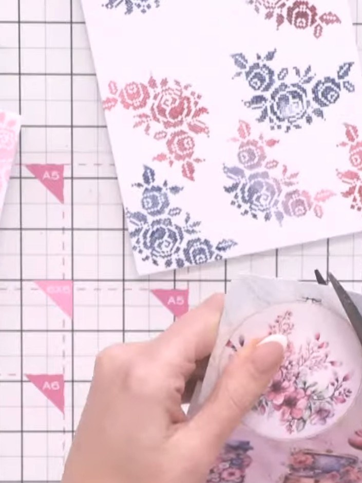 Step 4: Use the embroidery hoop die to cut out the design from your chosen paper. Position the die over the floral pat