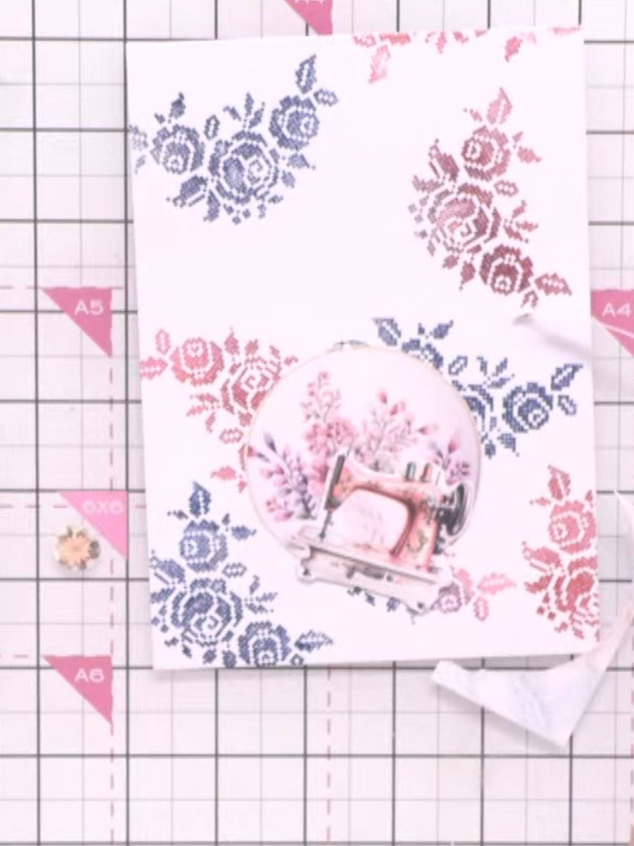 Step 7: Adhere the fussy-cut flowers and leaves around and inside the embroidery hoop using foam pads. Layer the flora