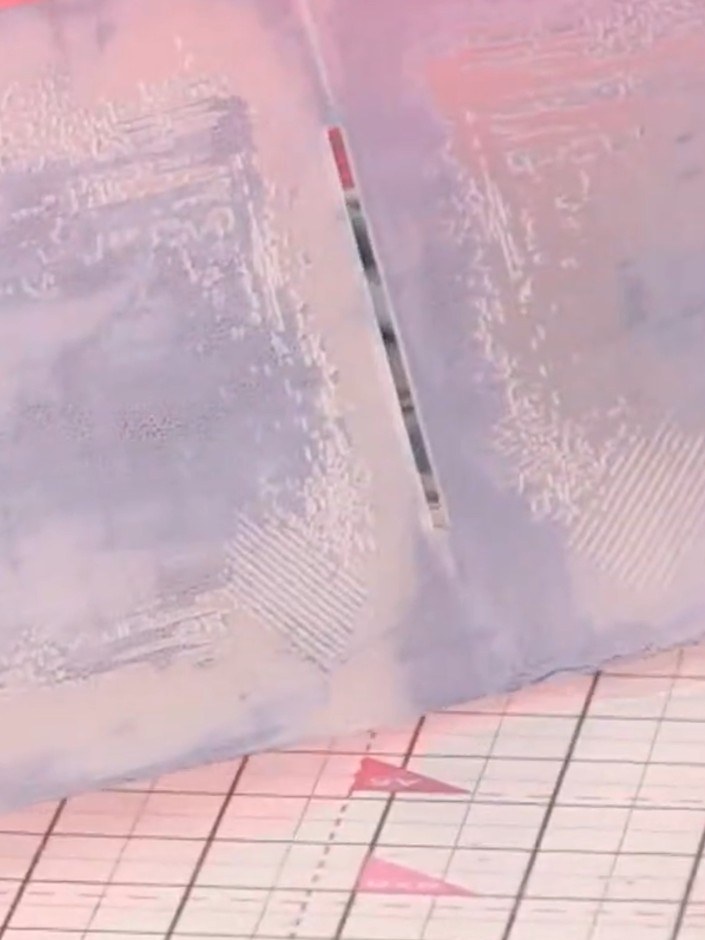 Step 3: Place a piece of white card into the embossing folder and run it through your die-cutting machine to create th