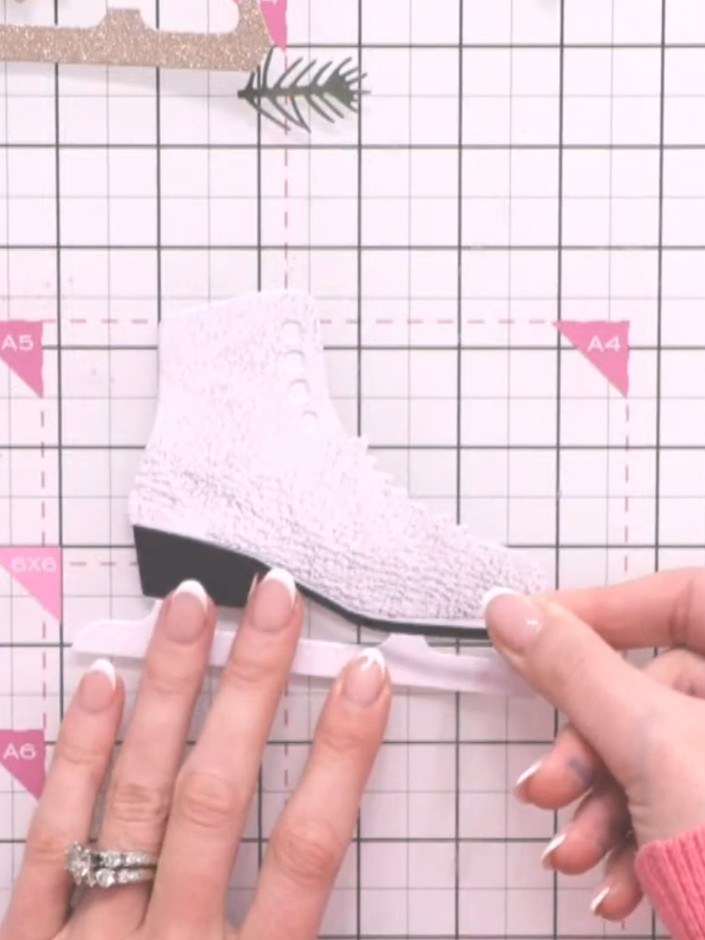 Step 4: Die-cut the heel piece from black leather-effect paper. Position it at the bottom of the boot, ensuring it is 