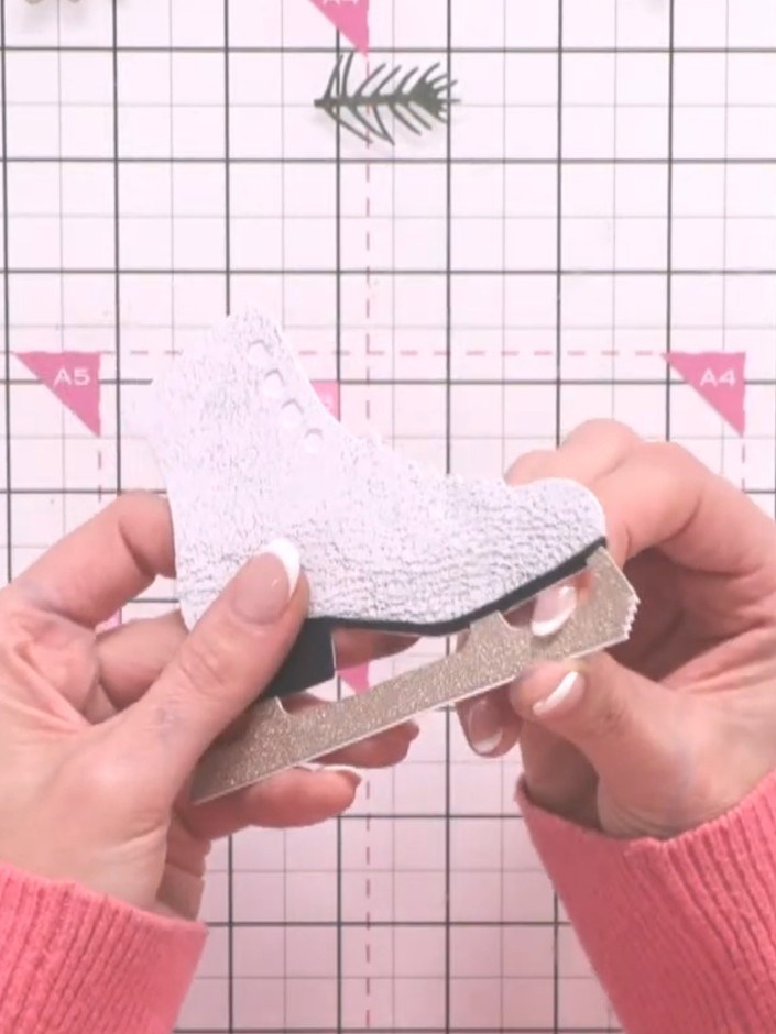 Step 5: Die-cut the blade from metallic card (gold or silver). Adhere the metallic blade to the bottom of the boot usi