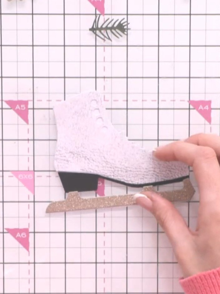 Step 6: Die-cut the laces from black cardstock using the Twinkling Toes die set. Layer the black laces across the fron