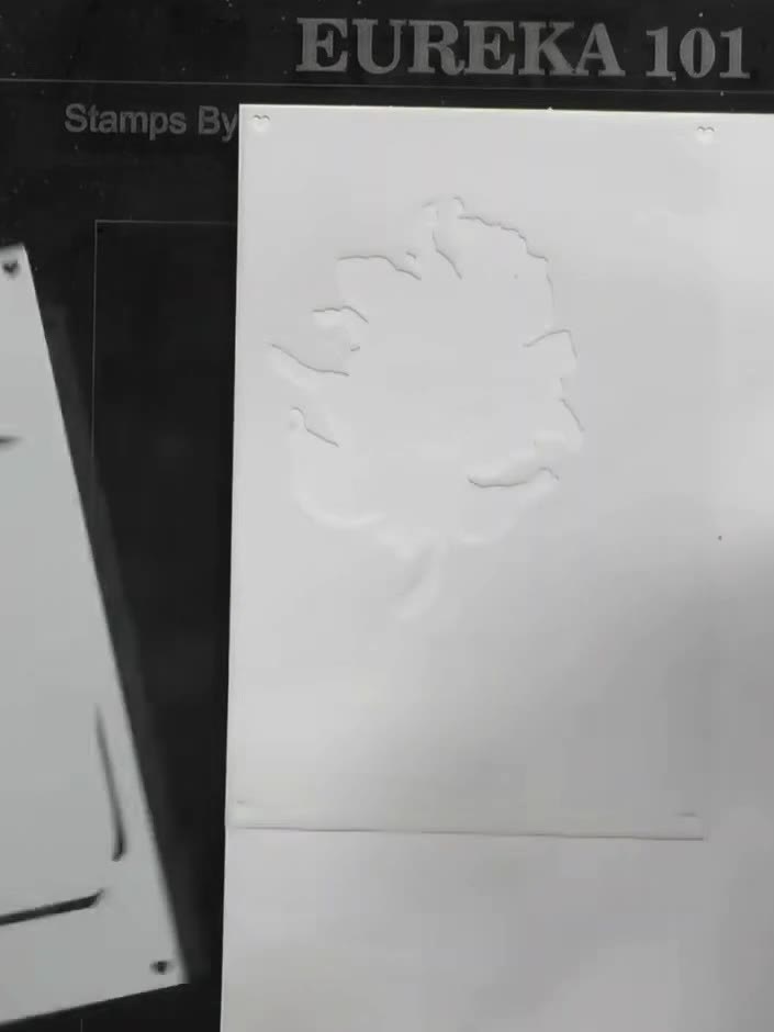 Step 1: Position the first layering stencil on your white card base, aligning it carefully to the edge. The stencil fe