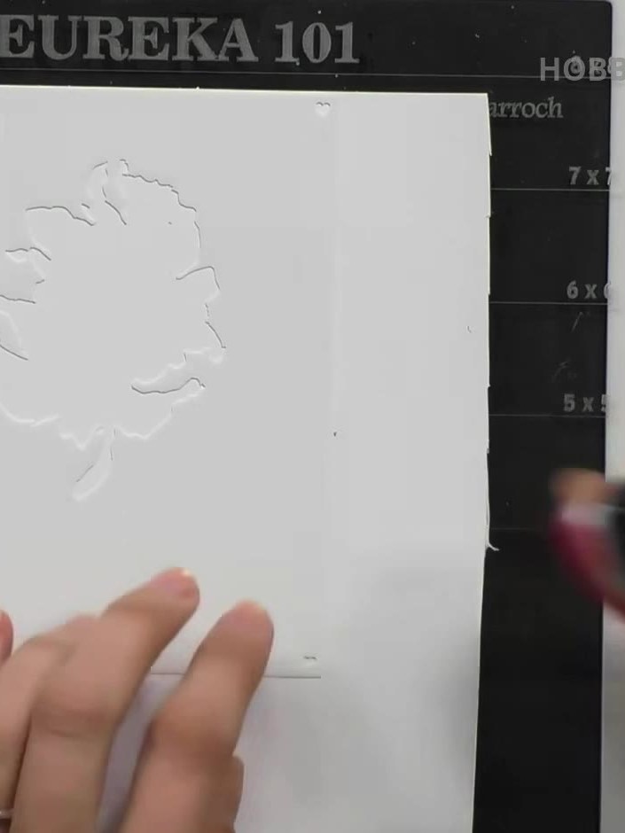 Step 2: Apply pink ink through the stencil onto the embossed flower area using an ink pad. Gently dab the ink pad over