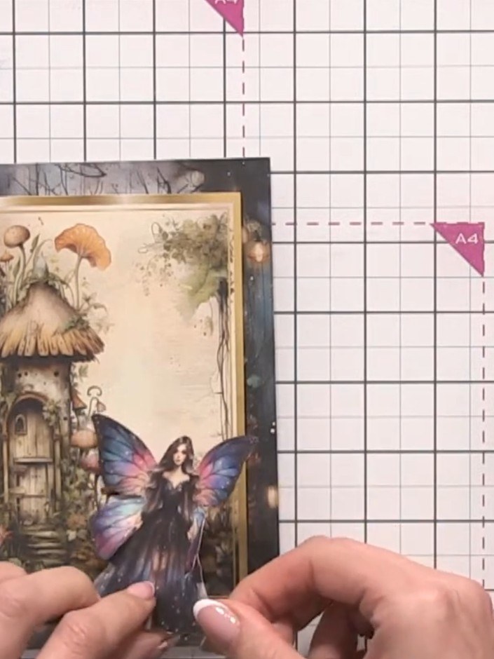 Step 7: Cut out the mushroom topper elements and position them at the fairy's feet using 3D foam pads to add dimension