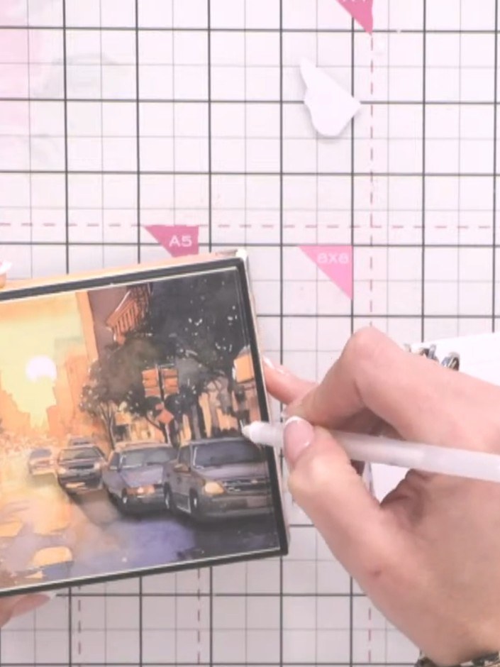 Step 9: Add iridescent glitter glue to the trees and other design elements on the sunset scene to create sparkle and d