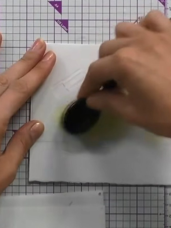 Step 2: Position the second stencil on your card and apply the same gold ink using the blending tool. Press firmly to 