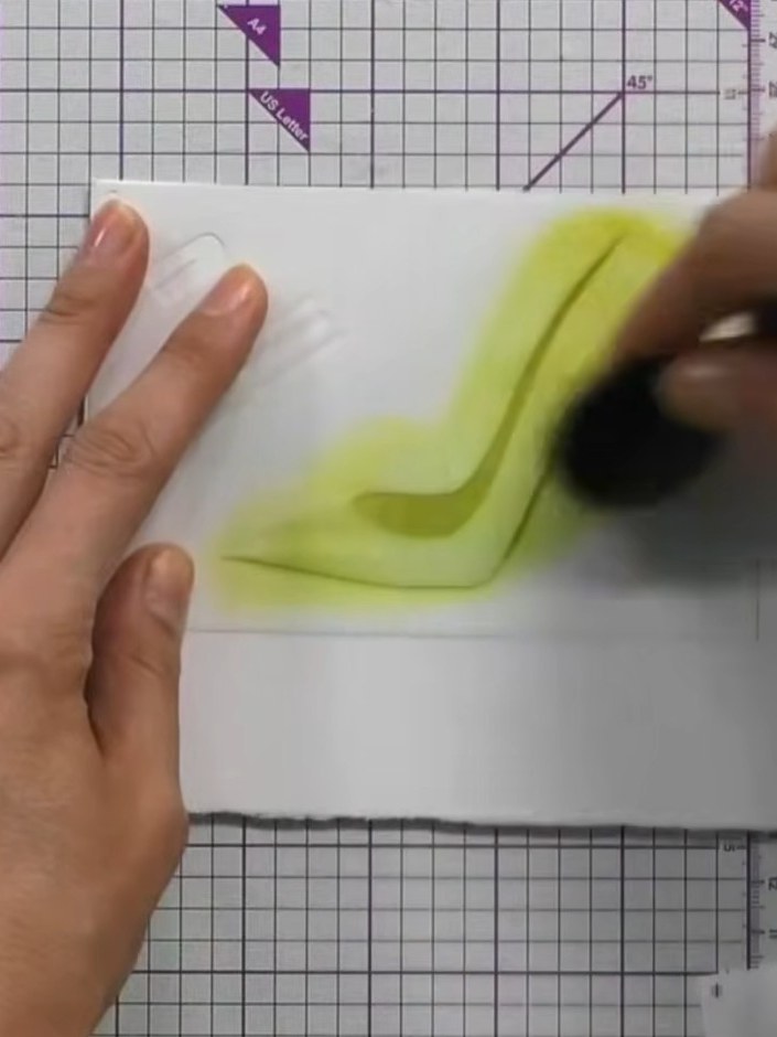 Step 3: Apply the third stencil layer using gold ink. Press down firmly with the blending tool to create light and sha