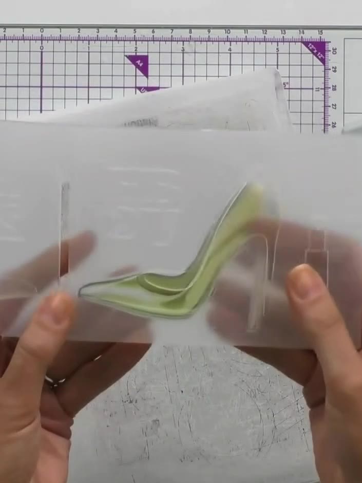 Step 6: Line up the die-cut green shoe with the embossing folder, ensuring the shoe aligns properly within the folder 