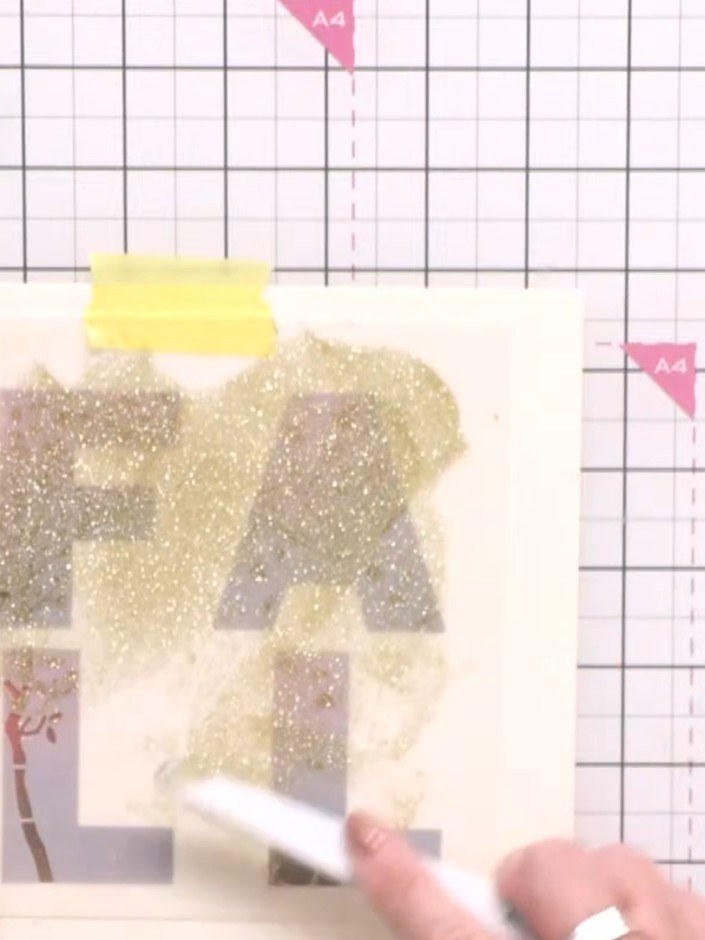 Step 4: Carefully lift the stencil away from the card to reveal the layered effect. The glittery Stellar Paste creates