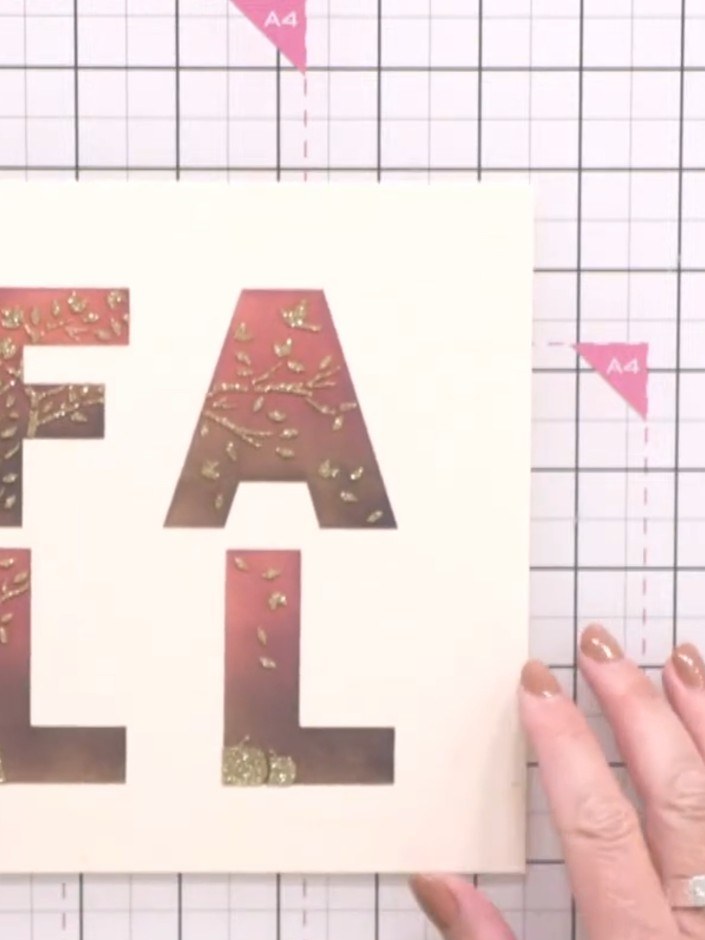 Step 5: Mat and layer the embossed 'FALL' panel onto dark brown cable-knit patterned paper from the Sweet Fall paper p