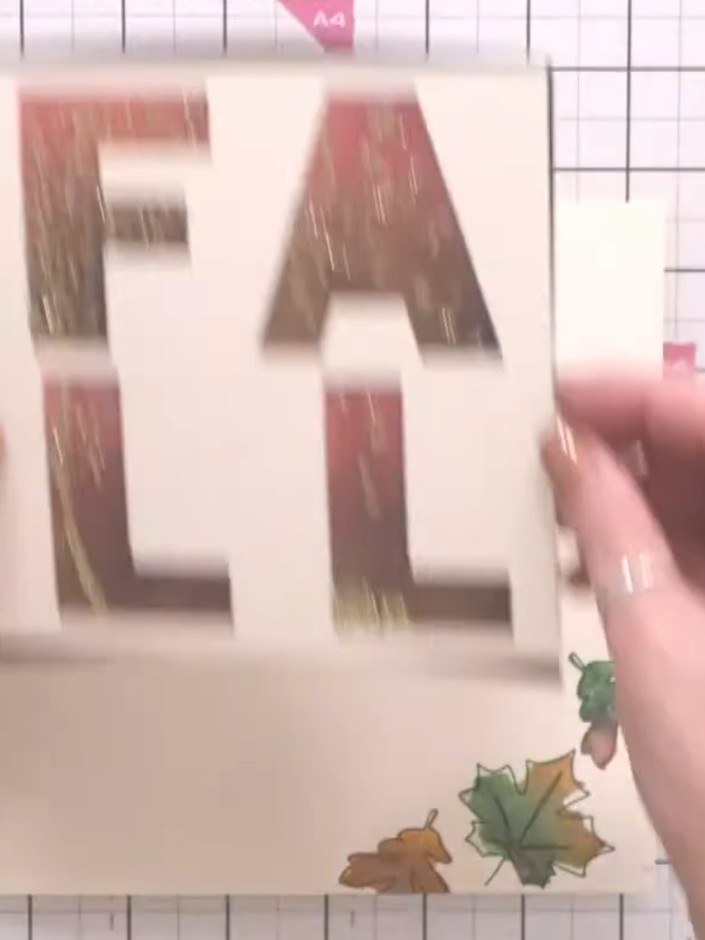 Step 6: Die cut the word 'FALL' from dark brown cardstock and layer it over a cream cardstock underlay. Position the s