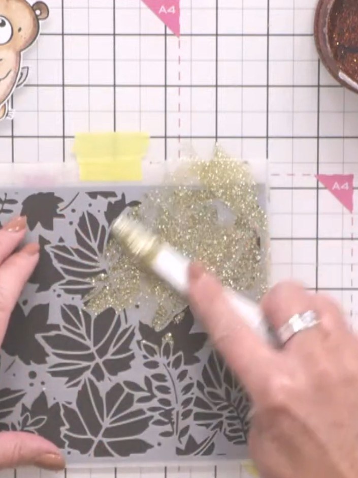 Step 2: Using a palette knife, spread champagne-on-ice Stella paste through the leaf stencil, covering the leaf areas.