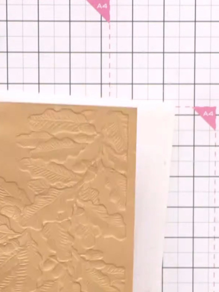 Step 1: Run a piece of copper card stock through your die-cutting machine with the oak leaf cascade embossing folder t