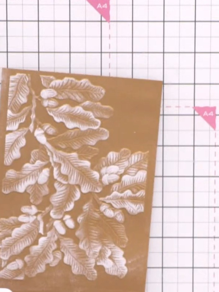 Step 3: Add splatter effects to the embossed panel using white ink or paint to create texture and visual interest acro