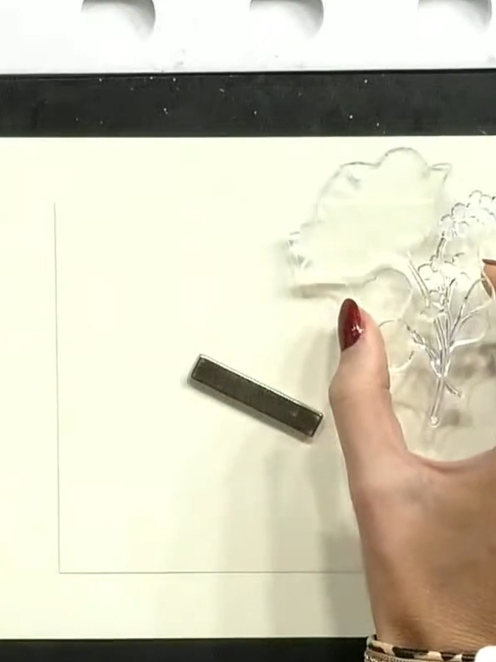 Step 3: Using purple ink, spot colour onto the flower centres of the stamp. Apply the ink directly to the raised flowe