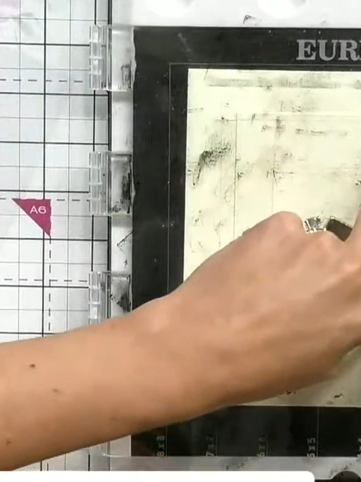Step 5: Apply green ink to the leaf areas of the stamp using a small brush or sponge. Work carefully to colour only th