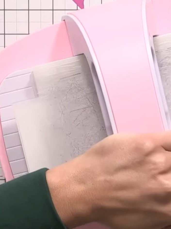 Step 1: Run the watercolour card through the embossing folder with the pink embossing machine to create the raised flo