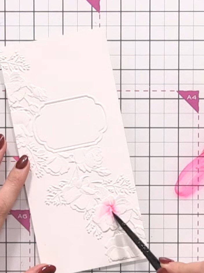 Step 3: Using a clean, damp brush, apply water to the coloured flower areas to help the pink and orange inks blend and