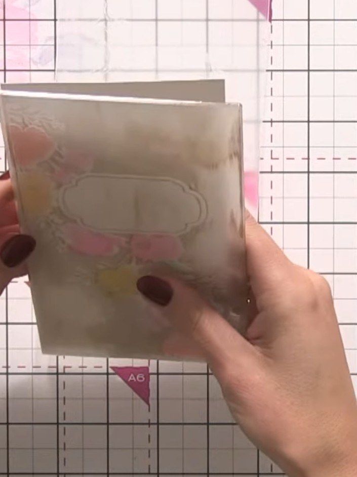 Step 7: Run the inked embossing folder through your die-cutting machine with the card base inside to transfer the brow